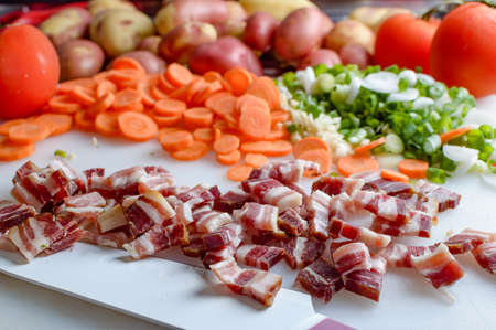Spring vegetables and bacon on the kitchen table.Healthy foods are on the table. Homemade food preparation.の写真素材