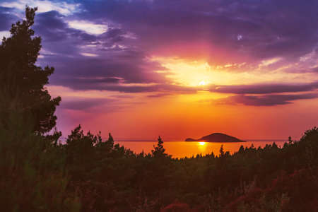 Kelifos island (Kelyfos, Turtle island) at sunset, Kelyfos island between Sithonia and Kassandra near Neos Marmaras, Greece.の写真素材
