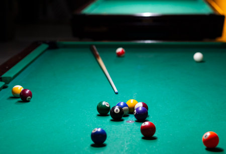 Billiard balls on green table with billiard cue. Snooker, pool game