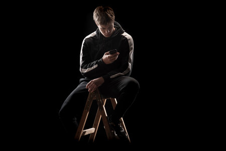 Young man in a sports suit with a smartphone.