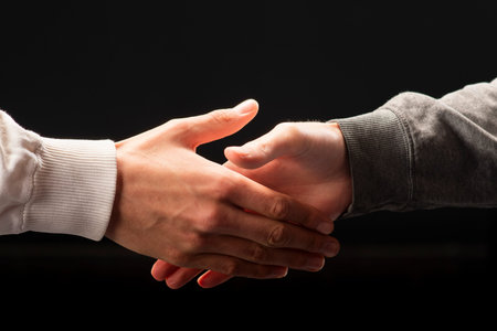 Handshake of two men after successful negotiations. Two friendly colleagues greeting each other.