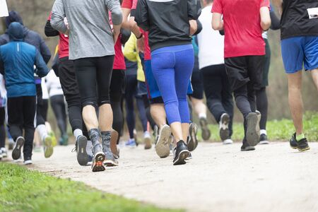 Fitness, sport, friendship, race and healthy lifestyle concept - group of friends or sportsmen running marathonの写真素材