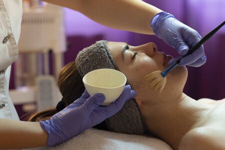 Spa, resort, beauty and health concept - beautiful woman in spa salon getting face treatment. Face skin care. Cosmetology の写真素材