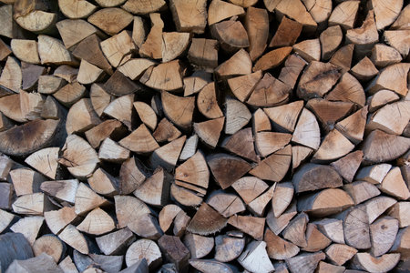 Firewood- wood chopped and arranged. Wood for heating, for fireplace. Rural natural background