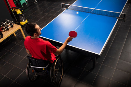Wheelchair user with a tennis racket in their hands. Rehabilitation of the disabled. Sport and a healthy lifestyle.の写真素材