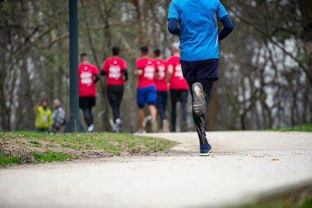 Fitness, sport, race and healthy lifestyle concept - Athletic young man running marathon in the...