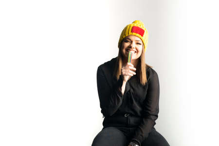 Portrait of young pretty funny smiling girl in cold weather and warm hatの写真素材