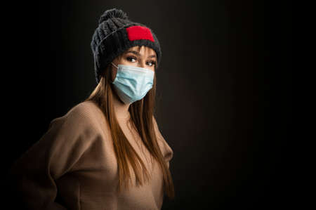 Portrait of young pretty girl in warm hatの写真素材