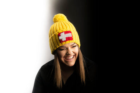 Portrait of young pretty funny smiling girl in cold weather and warm hat