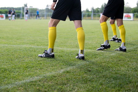 The referees go out on the field before the start of the football matchの写真素材