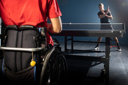 Wheelchair user with a tennis racket in their hands. Rehabilitation of the disabled. Sport and a...