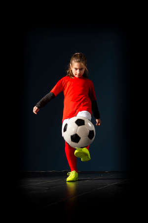 An elementary school girl is playing indoor soccerの写真素材