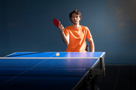 A wheelchair user plays table tennis. Rehabilitation of the disabled. Sport and a healthy lifestyle....