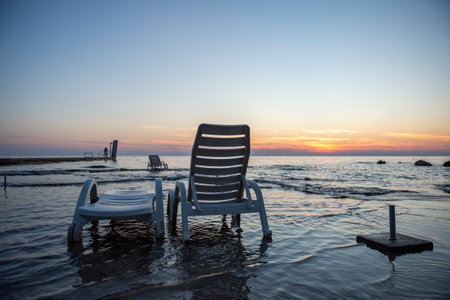 Empty sunbeds on the beach. Evening seascape. The beautiful world of Mediterranean countries. Umag, Istrian Peninsula, Croatiaの写真素材