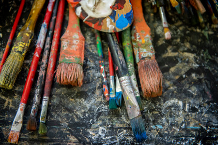 A lot dirty artist paint brushes in a bucket. Different artist brushes, close-up viewの写真素材