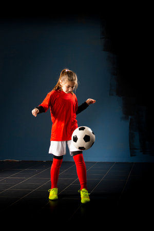 An elementary school girl is playing indoor soccerの写真素材