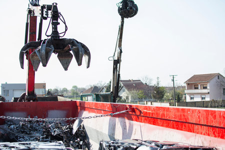 Crane grabber loading metal scrapの写真素材