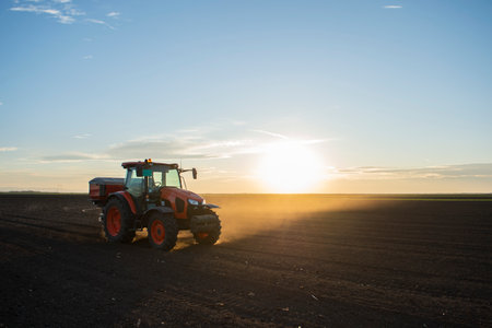 Tractor spreading artificial fertilizers. Transport, agricultural.の写真素材