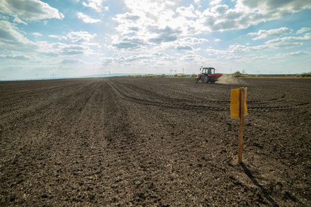 Tractor spreading artificial fertilizers. Transport, agricultural.の写真素材