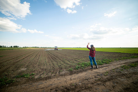 Young woman farmer in the field in spring