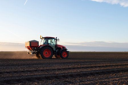 Tractor spreading artificial fertilizers. Transport, agricultural.