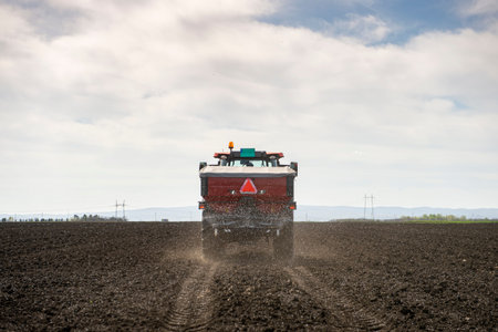 Tractor spreading artificial fertilizers. Transport, agricultural.