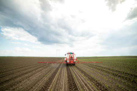Tractor spray fertilize field with insecticide herbicide chemicals in agriculture field