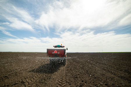 Tractor spreading artificial fertilizers. Transport, agricultural.