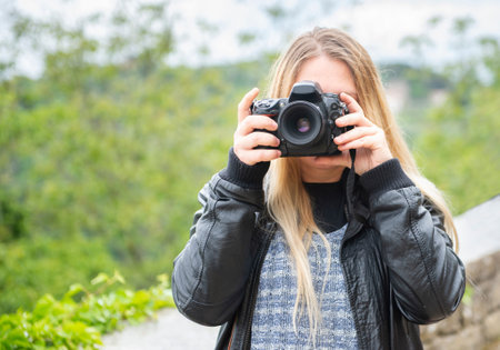 A female photographer takes pictures while visiting interesting tourist destinations. Croatia