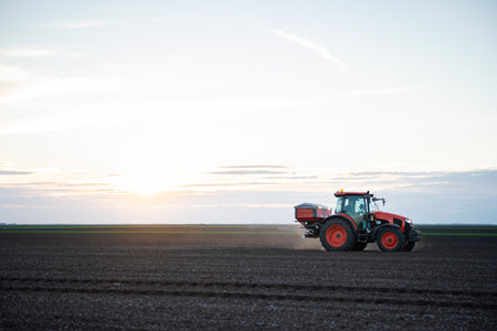 Tractor spreading artificial fertilizers. Transport, agricultural.の写真素材