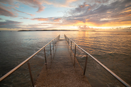 Entrance to the sea with a fence. Sunset. Fasana, Istrian Peninsula, Croatiaの写真素材