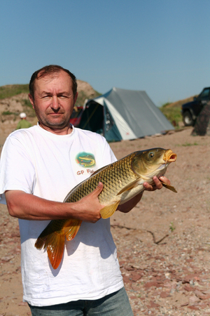 Fisherman with a big carp. Khakassia, Russia. Freshwater seaの写真素材