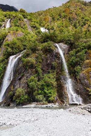 A small double waterfall on the way to Franz Josef Glacier. South island new zealandの写真素材