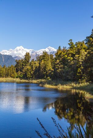 Mountains are reflected in the lake. Matheson lake, New Zealandの写真素材