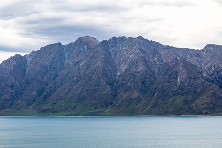 Sheer cliffs by the lake. New zealandの写真素材