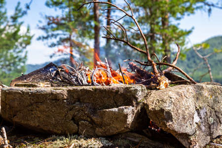Fishermen's bivouac on the island. A burning bonfire. Lake Tagasuk. Russiaの写真素材