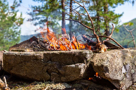 Fishermen's bivouac on the island. A burning bonfire. Lake Tagasuk. Krasnoyarsk Territory, Siberia, Russiaの写真素材