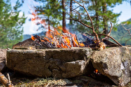 Fishermen's bivouac on the island. A burning bonfire. Lake Tagasuk. Siberia, Russiaの写真素材