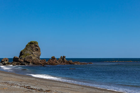 Coastal landscape with rocks on the beach and blue sky. Cape Giant. Bizarre rocks. Okhotsk Sea coast. Sakhalin, Russiaの写真素材