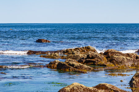 Beautiful seascape with rocks, sea and blue sky. Cape Giant. Bizarre rocks. Okhotsk Sea coast. Sakhalin, Russiaの写真素材