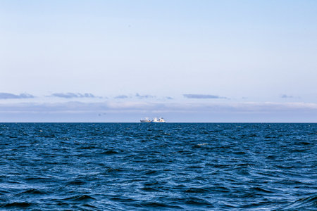 Seascape with a ship in the distance. View from the sea. Aniva Bay. South Sakhalin, Russiaの写真素材