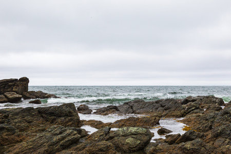Beautiful seascape with rocks and sea in cloudy day. Cape Acute. South Sakhalin, Russia