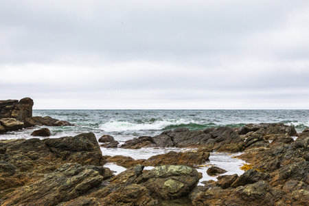 Seascape with rocks and sea waves. Cloudy day. Cape Acute. South Sakhalin, Russiaの写真素材