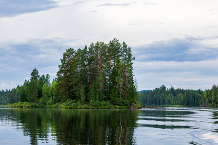 The shore of the lake in the taiga in the summer. Landscapes of Lake Tagasuk. Islands on the lake. Siberia, Russiaの写真素材