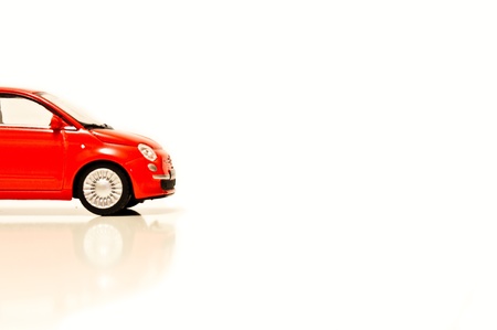 Red toy car on white isolated backgroundの写真素材
