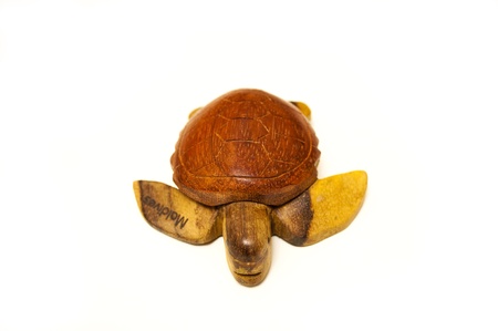 Wooden figurine of turtle on white backgroundの写真素材