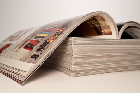 magazine on a stack of magazinesの写真素材