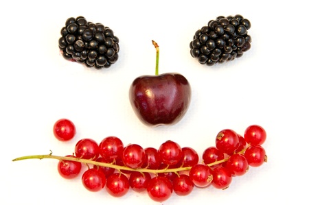 funny face from different berries on a white backgroundの写真素材