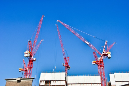 red construction  cranes on blue sky backgroundのeditorial素材