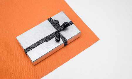 silver gift box with bow on white backgroundの写真素材